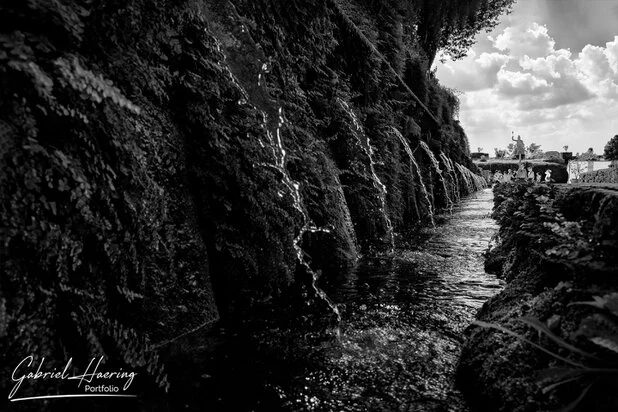 Black and white water channel and garden perspective at Villa d’Este near Rome