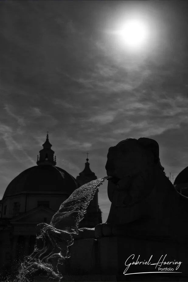 Black and white fountain silhouette under strong Roman sunlight