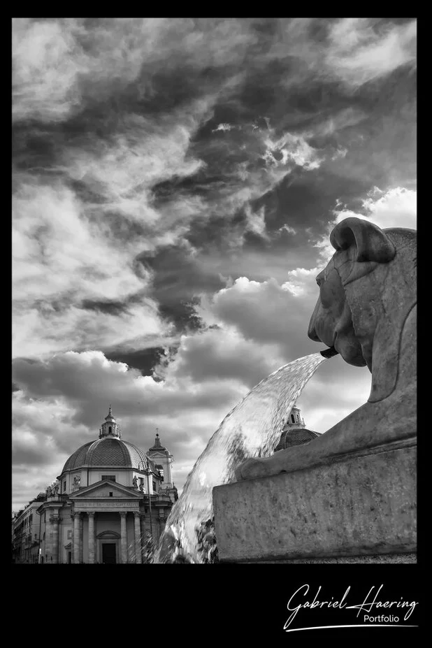 Black and white fountain and dramatic clouds above Rome