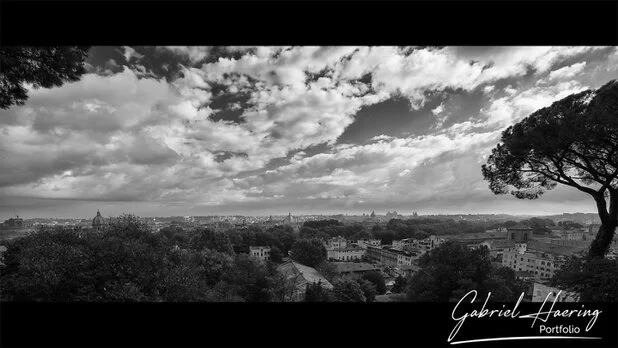 Black and white panoramic cityscape of Rome from a hilltop viewpoint