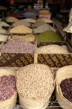 Busy Zanzibar market with vendors selling fresh fish and aromatic spices in a colorful setting.